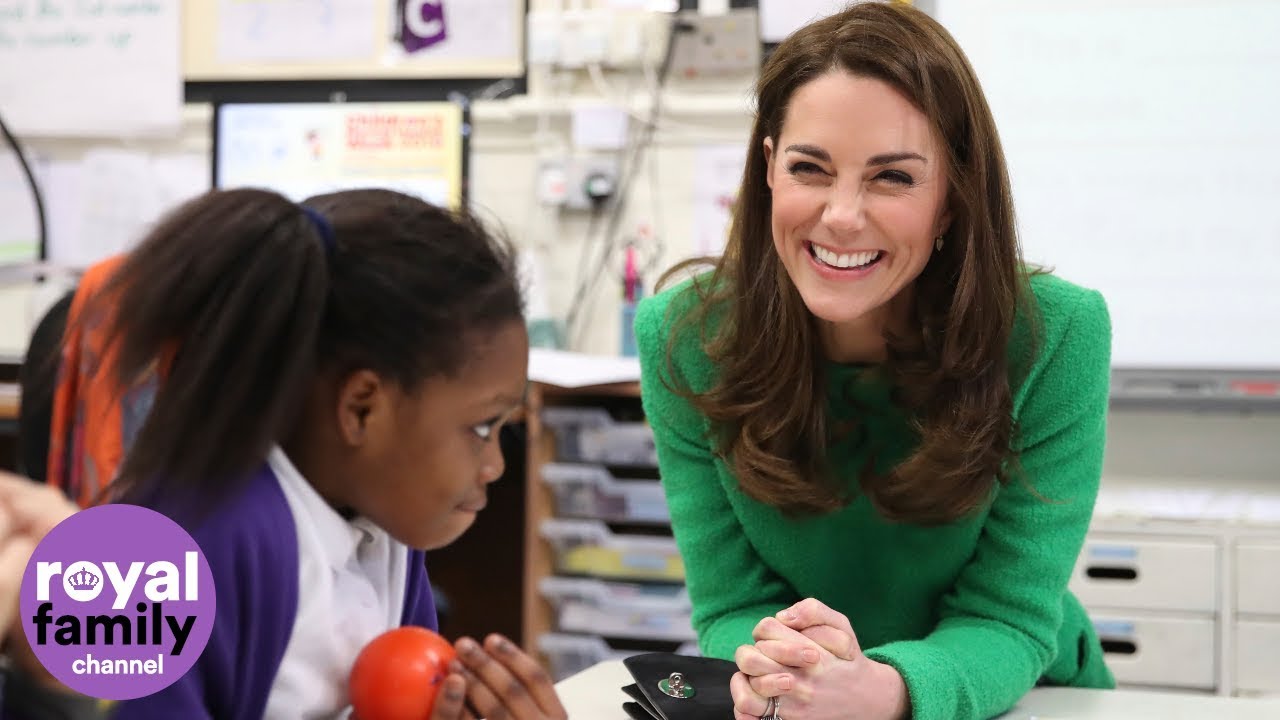 Duchess of Cambridge greeted by cute pup and shows off family photo on school tour