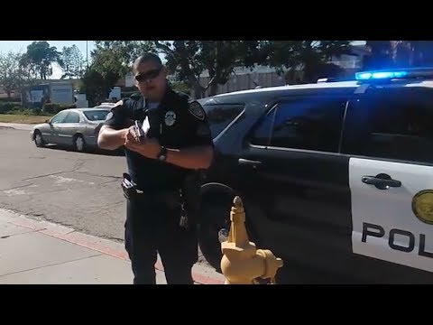 San Diego College Cop Points Gun at Photographer